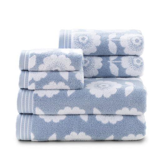 Clean stack of Caro Home's Flower Fields towel ser in light blue